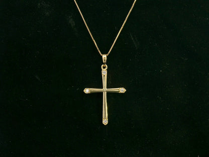 18K yellow gold diamond cross pendant with minimalist design by Emirates Diamonds.