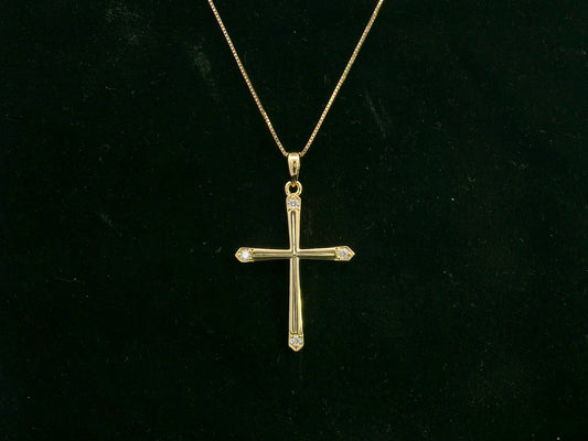 18K yellow gold diamond cross pendant with minimalist design by Emirates Diamonds.