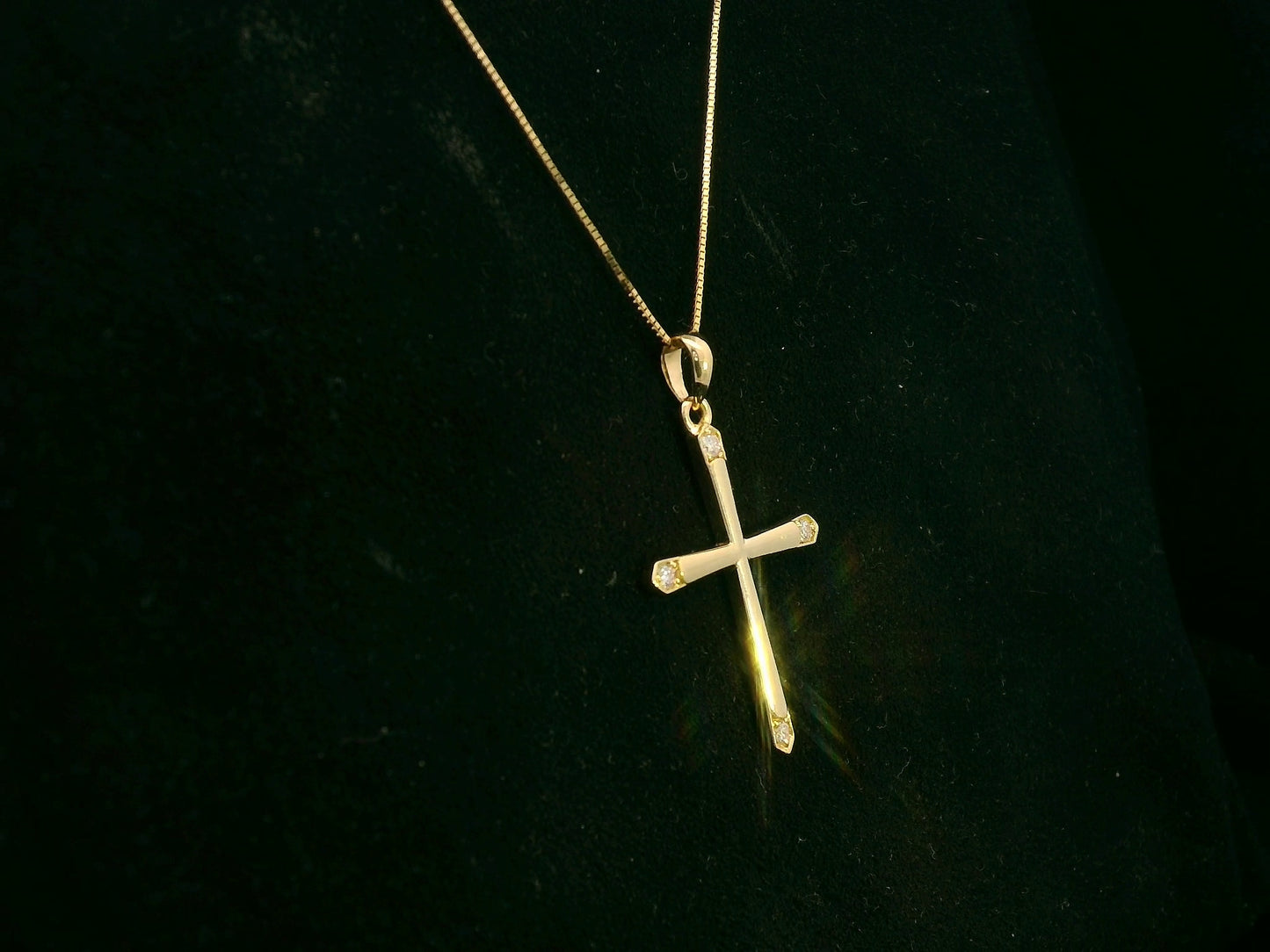 18K yellow gold diamond cross pendant with minimalist design by Emirates Diamonds.