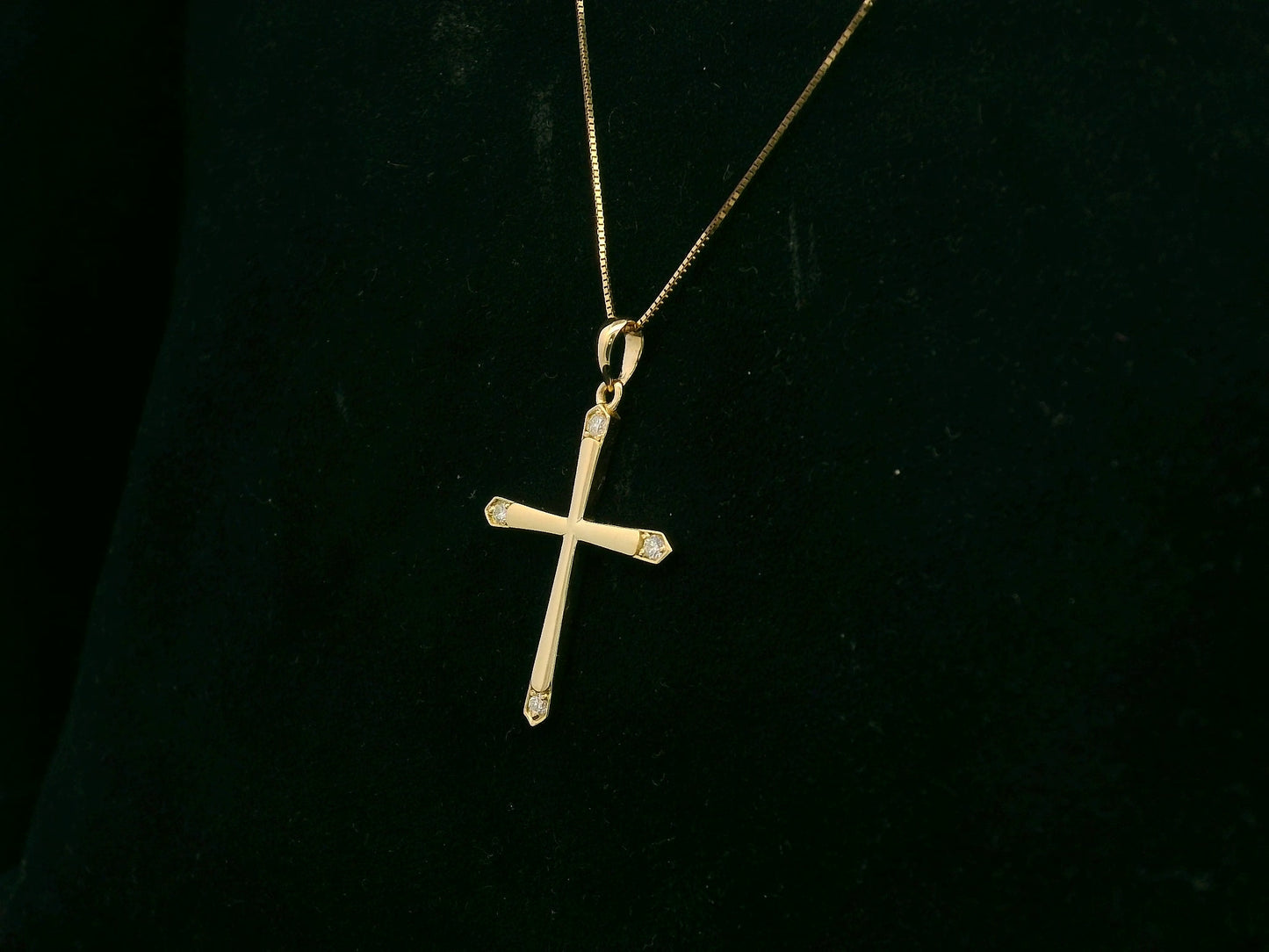 18K yellow gold diamond cross pendant with minimalist design by Emirates Diamonds.