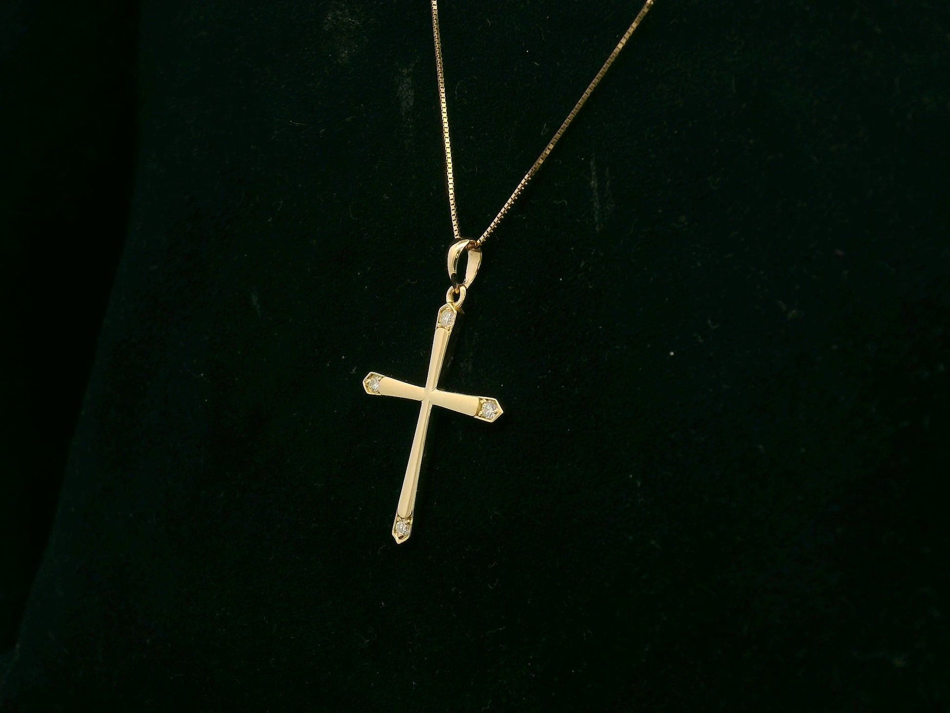 18K yellow gold diamond cross pendant with minimalist design by Emirates Diamonds.