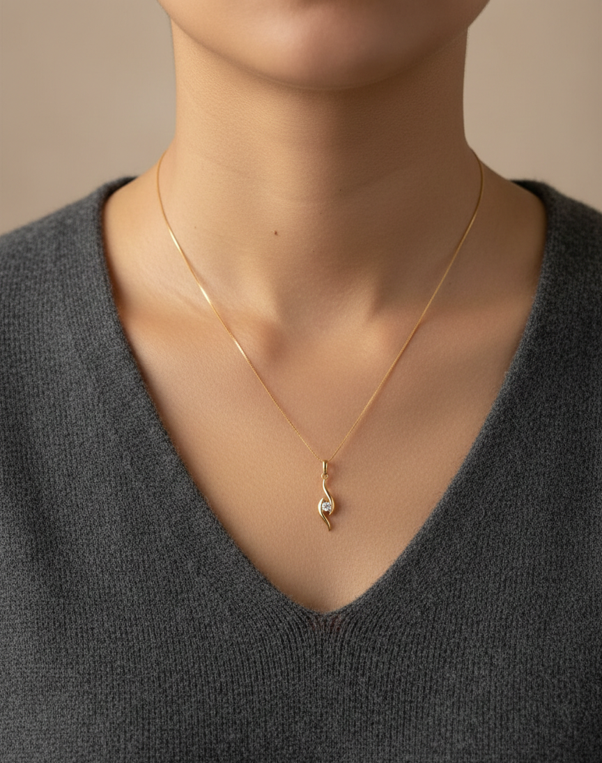 18K yellow gold diamond swirl pendant necklace featuring a 0.11 carat round diamond by Emirates Diamonds