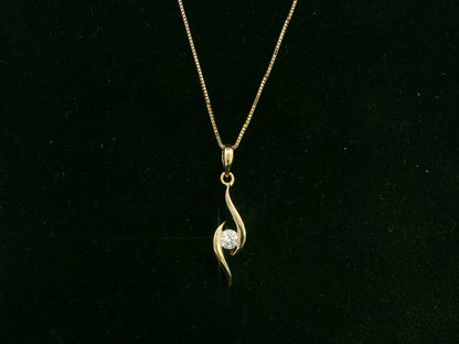 18K yellow gold diamond swirl pendant necklace featuring a 0.11 carat round diamond by Emirates Diamonds