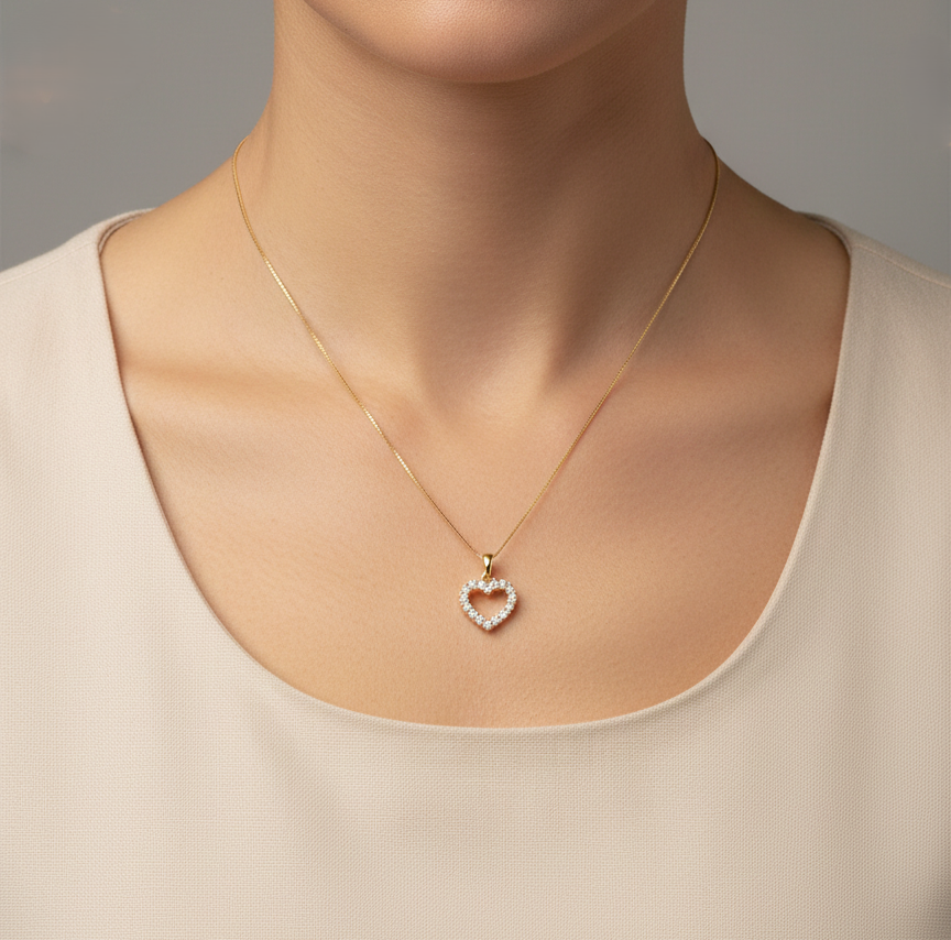 18K yellow gold diamond heart pendant with pavé-set diamonds, elegant open heart design by Emirates Diamonds.