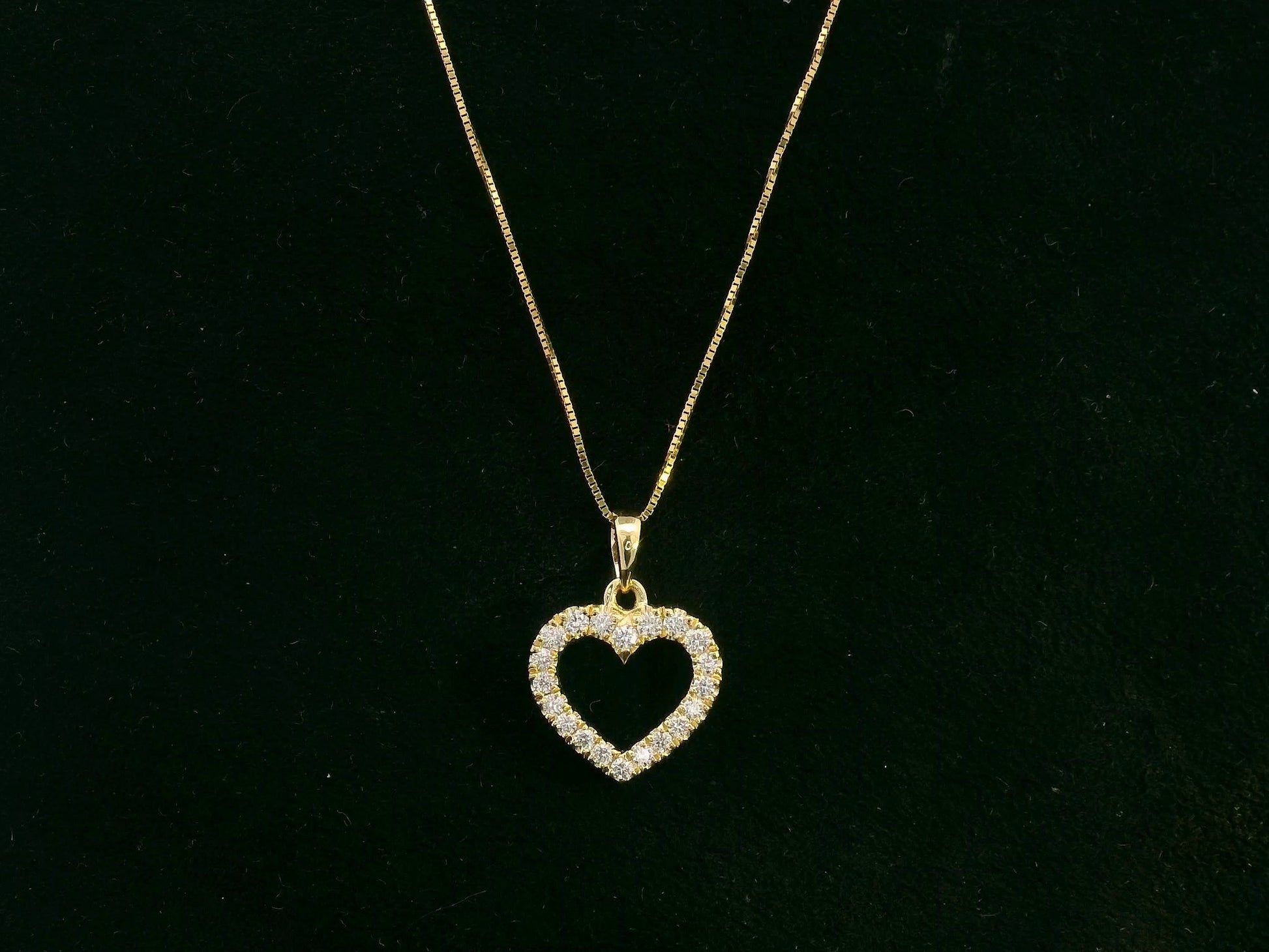 18K yellow gold diamond heart pendant with pavé-set diamonds, elegant open heart design by Emirates Diamonds.