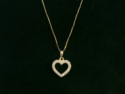 18K yellow gold diamond heart pendant with pavé-set diamonds, elegant open heart design by Emirates Diamonds.
