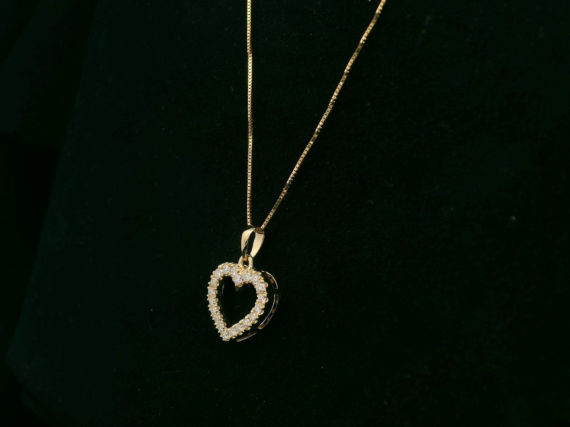 18K yellow gold diamond heart pendant with pavé-set diamonds, elegant open heart design by Emirates Diamonds.