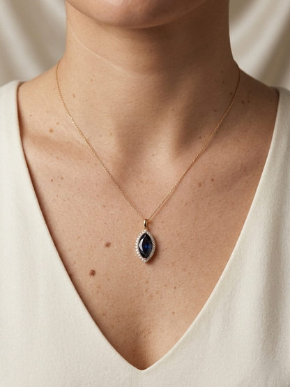 Marquise blue sapphire and diamond halo pendant in 18K yellow gold with chain – Emirates Diamonds
