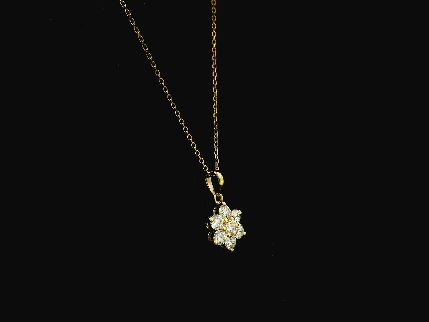 Diamond flower cluster pendant in 18K yellow gold featuring 0.55 carats of diamonds by Emirates Diamonds.