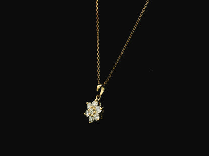 Diamond flower cluster pendant in 18K yellow gold featuring 0.55 carats of diamonds by Emirates Diamonds.