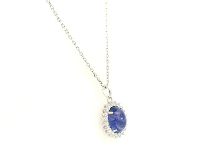 Cabochon tanzanite diamond halo pendant in 18K white gold