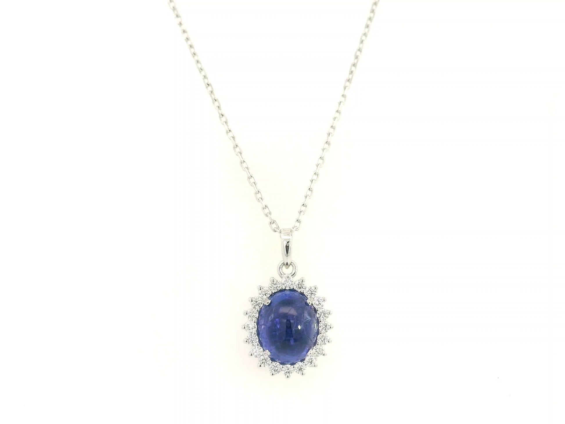 Cabochon tanzanite diamond halo pendant in 18K white gold