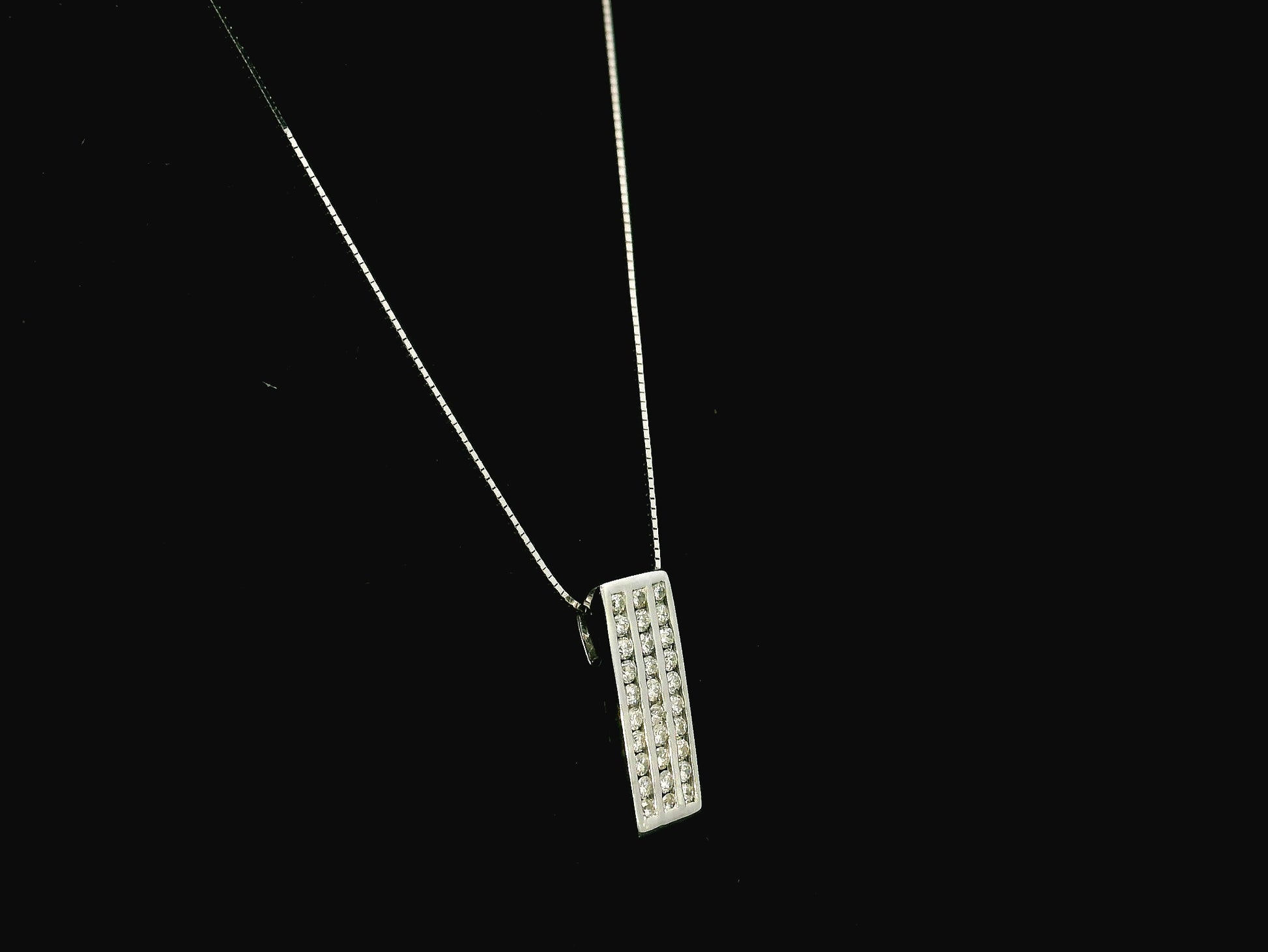 18K white gold diamond bar pendant featuring three vertical rows of natural diamonds with a total diamond weight of 0.54 carat.