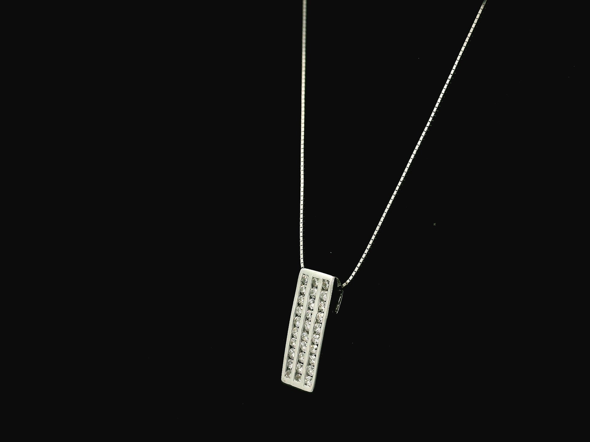 18K white gold diamond bar pendant featuring three vertical rows of natural diamonds with a total diamond weight of 0.54 carat.