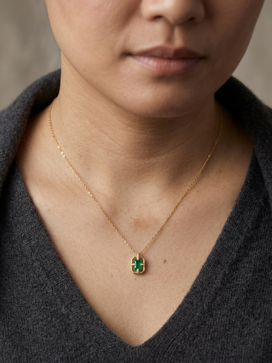 Emerald cut emerald geometric pendant necklace in 18K yellow gold with diamond accents