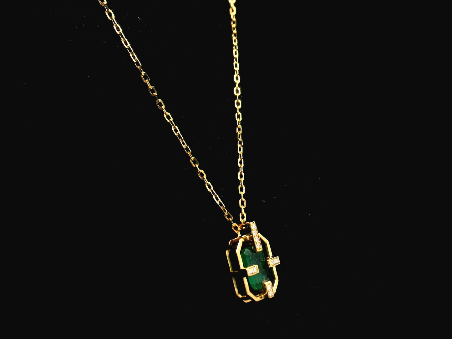 Emerald cut emerald geometric pendant necklace in 18K yellow gold with diamond accents