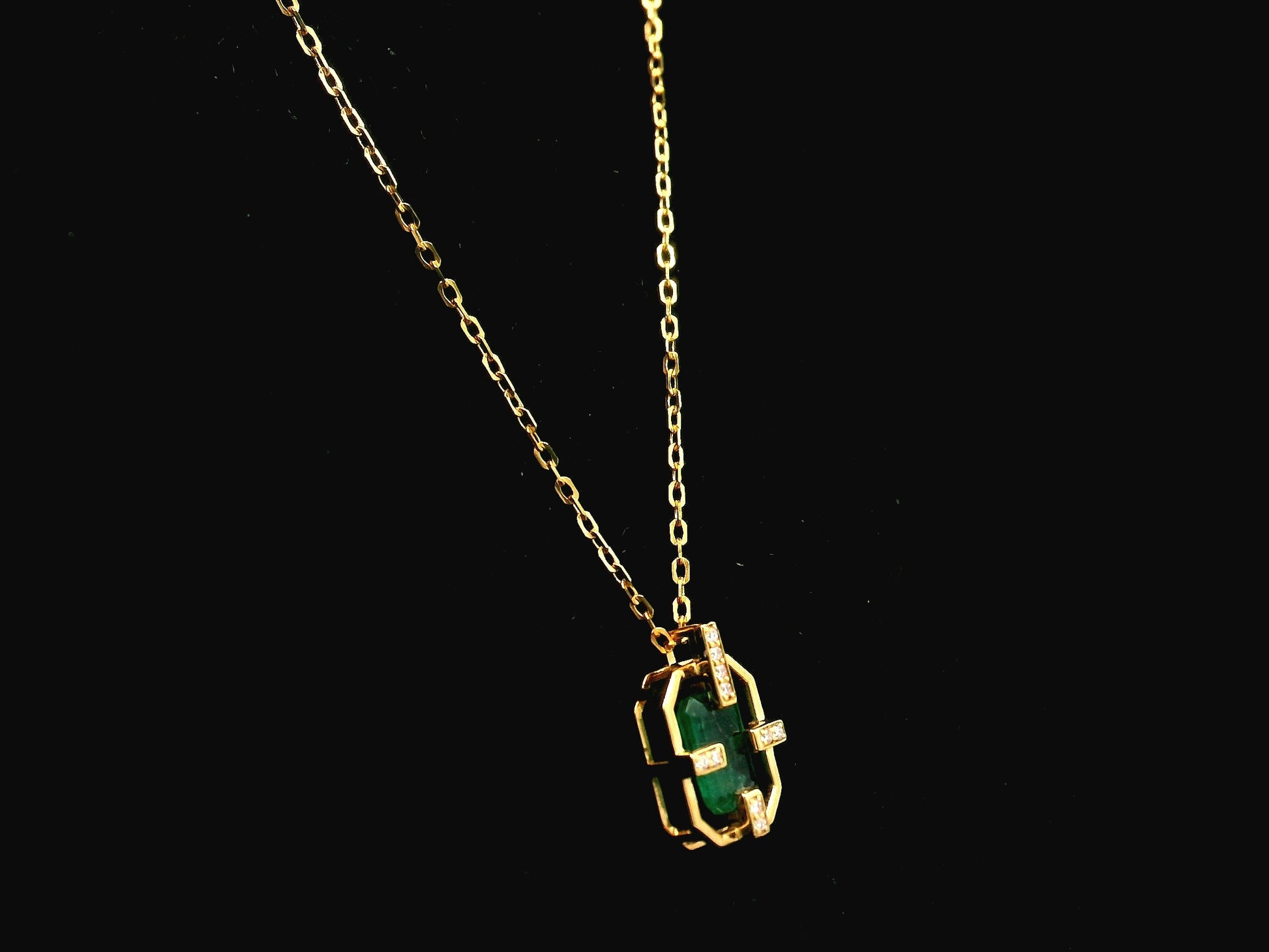 Emerald cut emerald geometric pendant necklace in 18K yellow gold with diamond accents