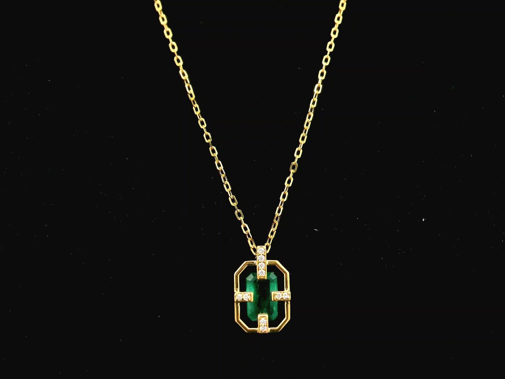 Emerald cut emerald geometric pendant necklace in 18K yellow gold with diamond accents