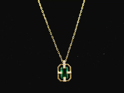 Emerald cut emerald geometric pendant necklace in 18K yellow gold with diamond accents
