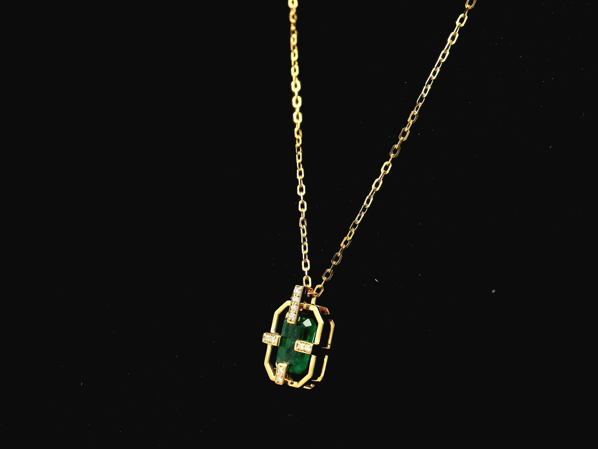 Emerald cut emerald geometric pendant necklace in 18K yellow gold with diamond accents