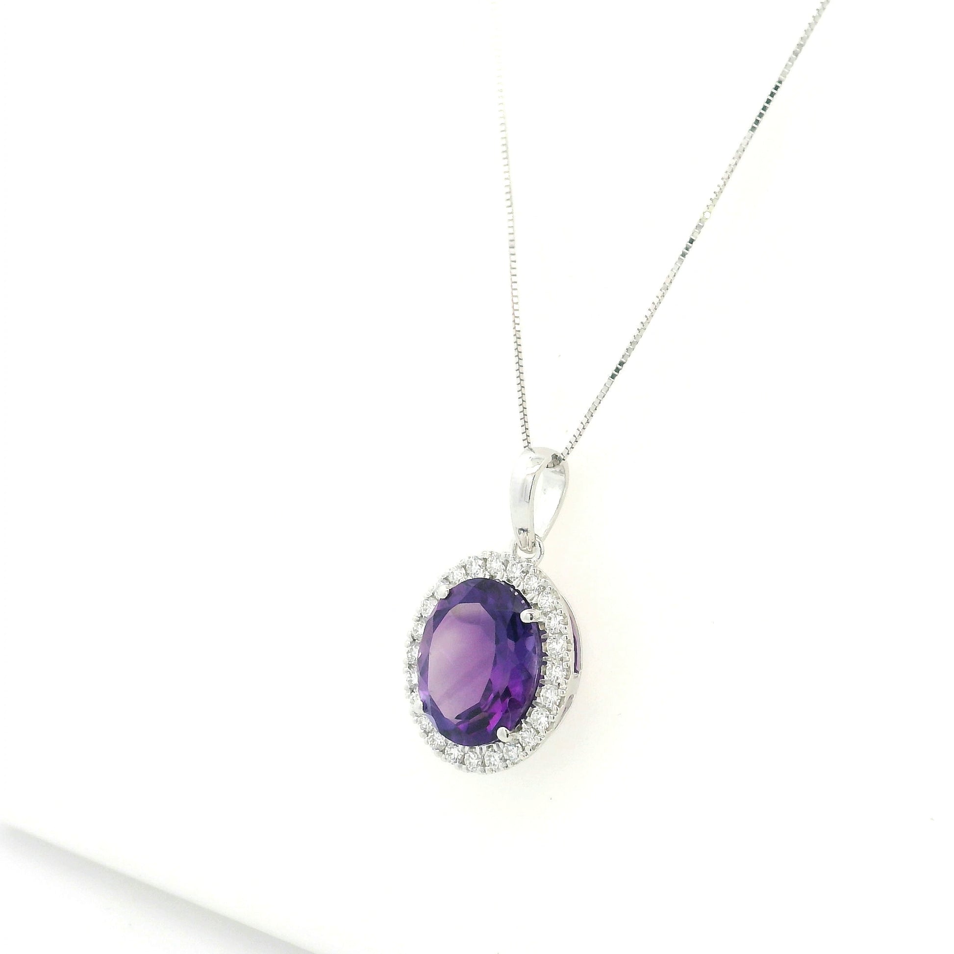 18K white gold amethyst and diamond halo pendant with oval purple gemstone