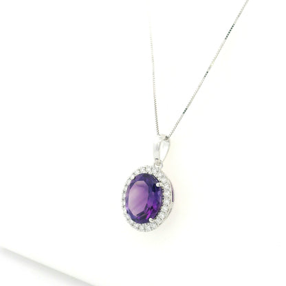 18K white gold amethyst and diamond halo pendant with oval purple gemstone