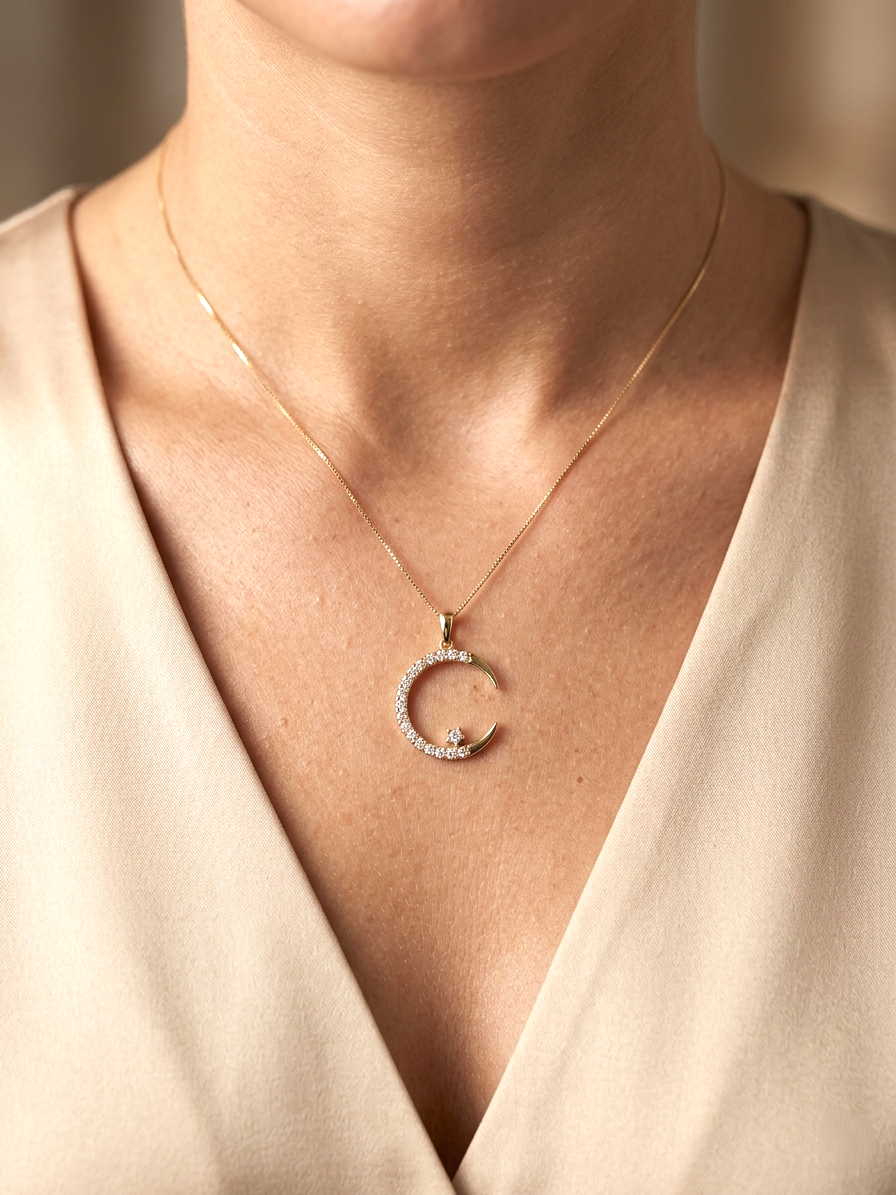 Diamond crescent moon pendant in 18K yellow gold by Emirates Diamonds