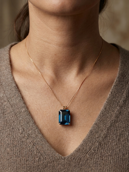 London Blue Topaz pendant in 18K yellow gold featuring a 14.77 carat emerald-cut natural London Blue Topaz