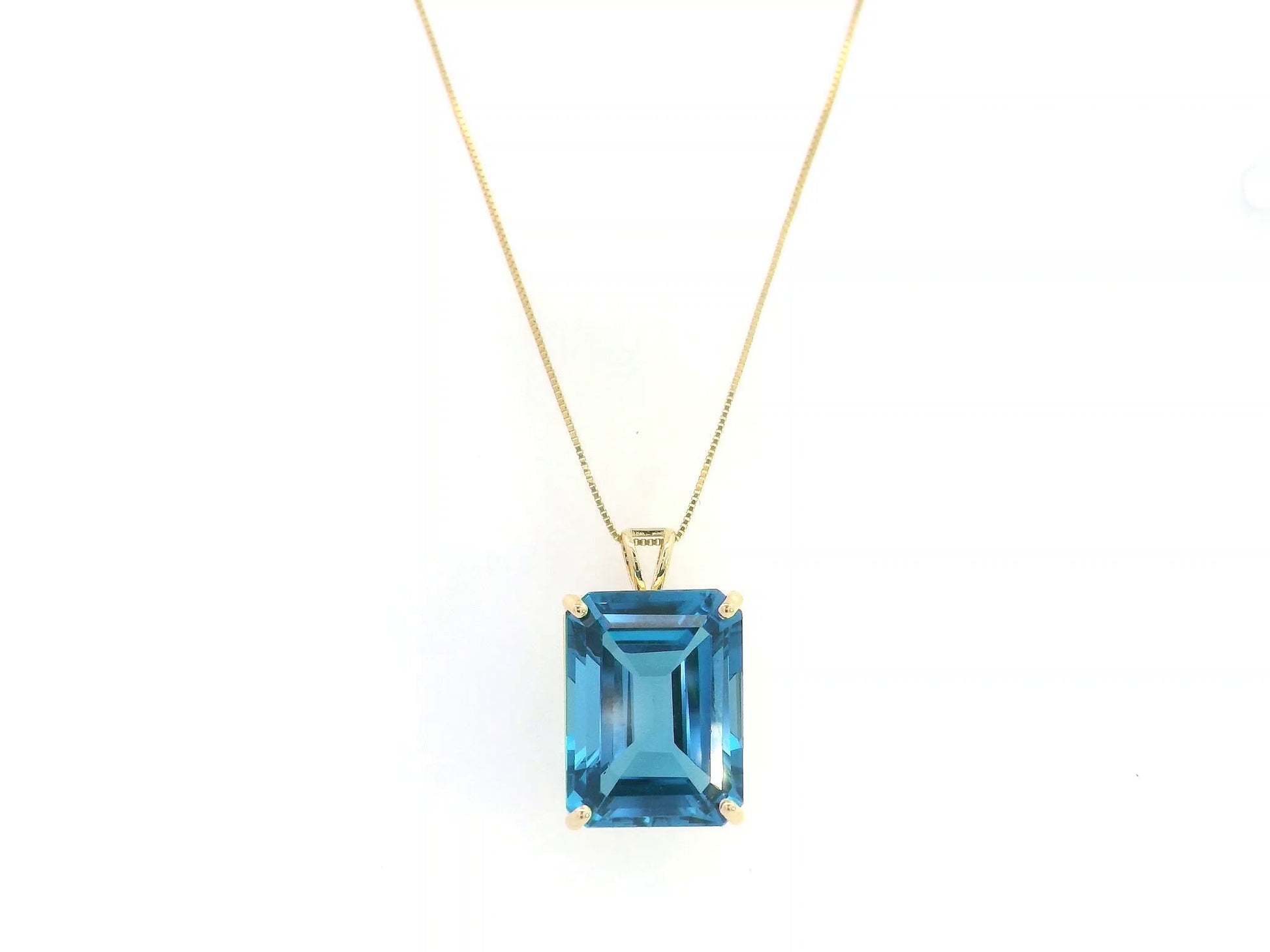 London Blue Topaz pendant in 18K yellow gold featuring a 14.77 carat emerald-cut natural London Blue Topaz