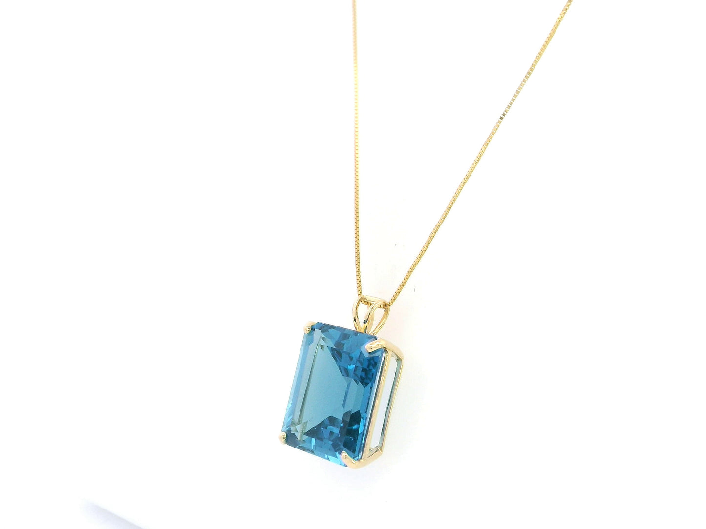 London Blue Topaz pendant in 18K yellow gold featuring a 14.77 carat emerald-cut natural London Blue Topaz