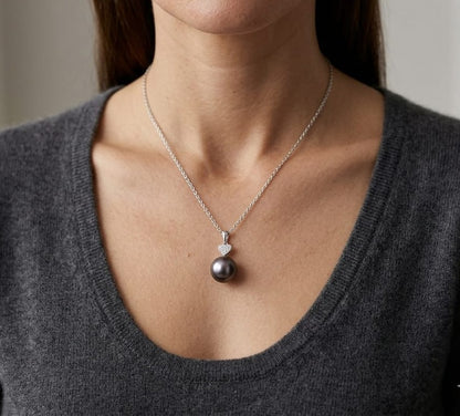Tahitian black pearl diamond heart pendant in 18K white gold with natural diamond accent.