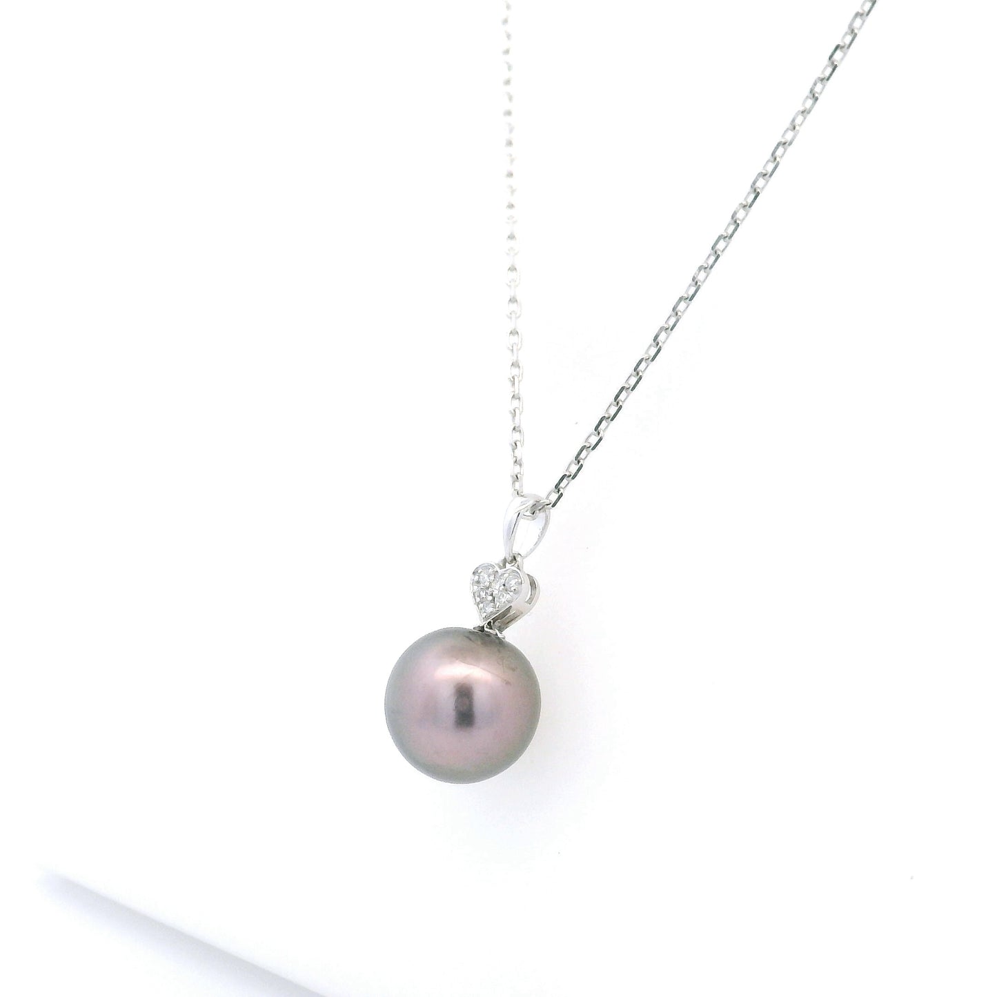 Tahitian black pearl diamond heart pendant in 18K white gold with natural diamond accent.
