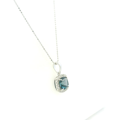 Cushion-cut London Blue Topaz diamond halo pendant in 18K white gold.