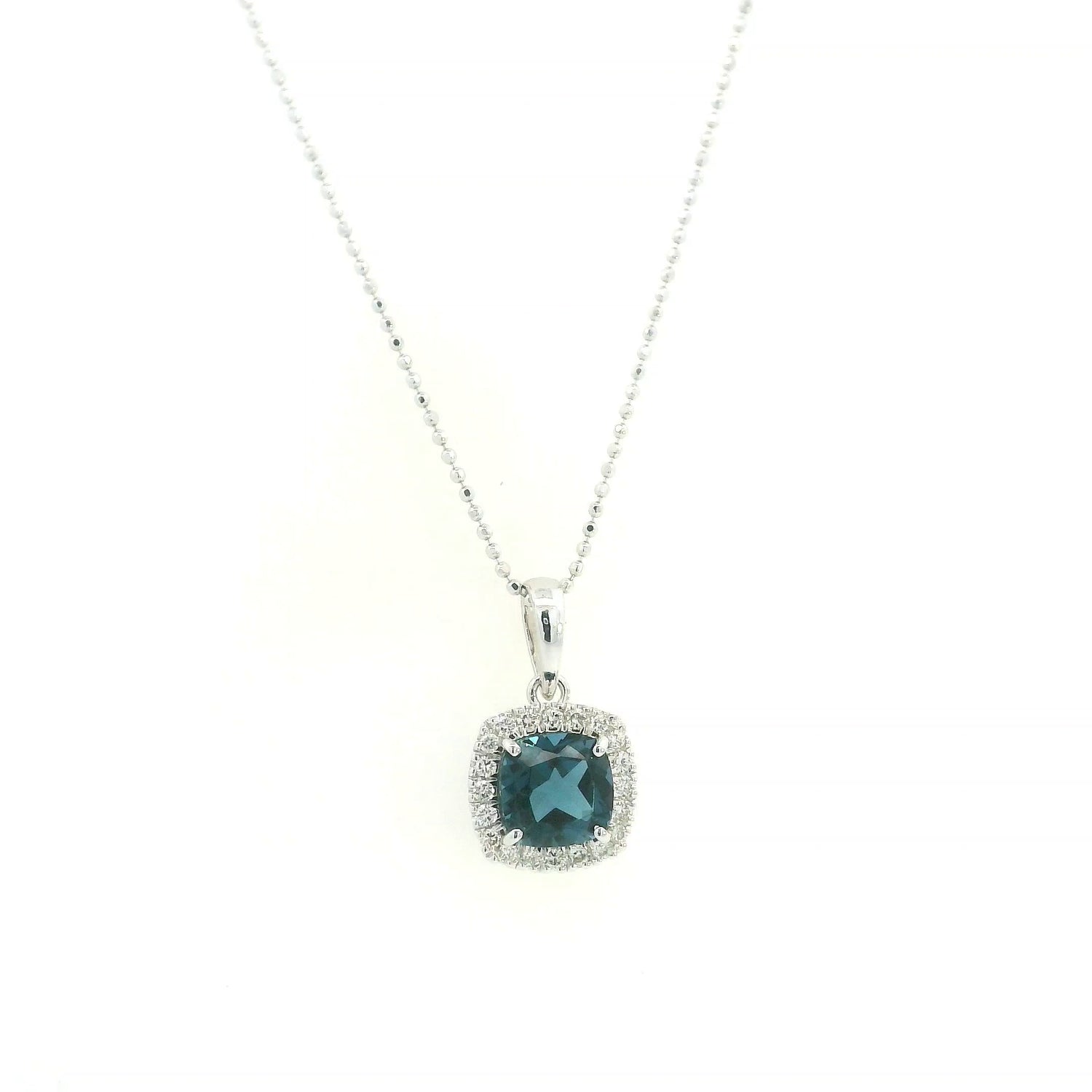 Cushion-cut London Blue Topaz diamond halo pendant in 18K white gold.