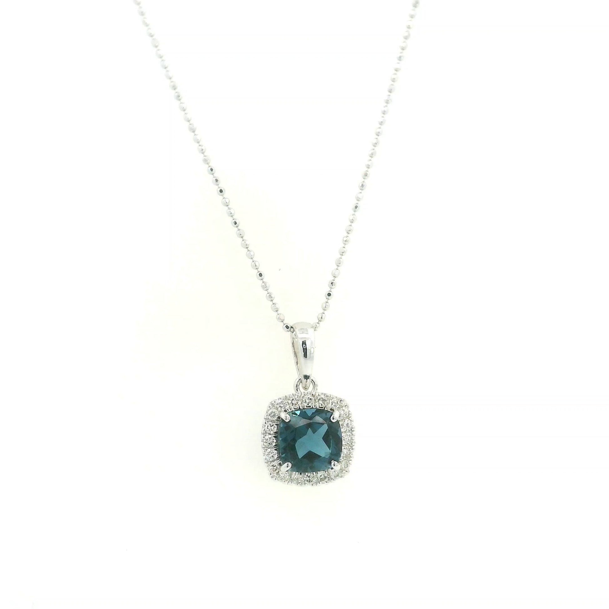 Cushion-cut London Blue Topaz diamond halo pendant in 18K white gold.