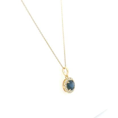 Round blue sapphire diamond halo pendant in 18K white gold.