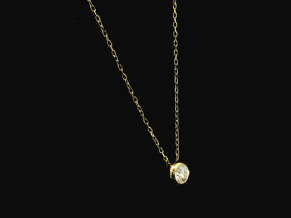 18K yellow gold diamond solitaire necklace featuring a 0.43 carat natural diamond in a modern bezel setting.