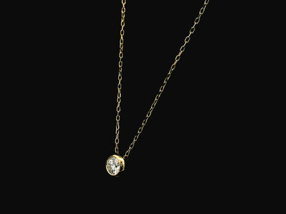 18K yellow gold diamond solitaire necklace featuring a 0.43 carat natural diamond in a modern bezel setting.