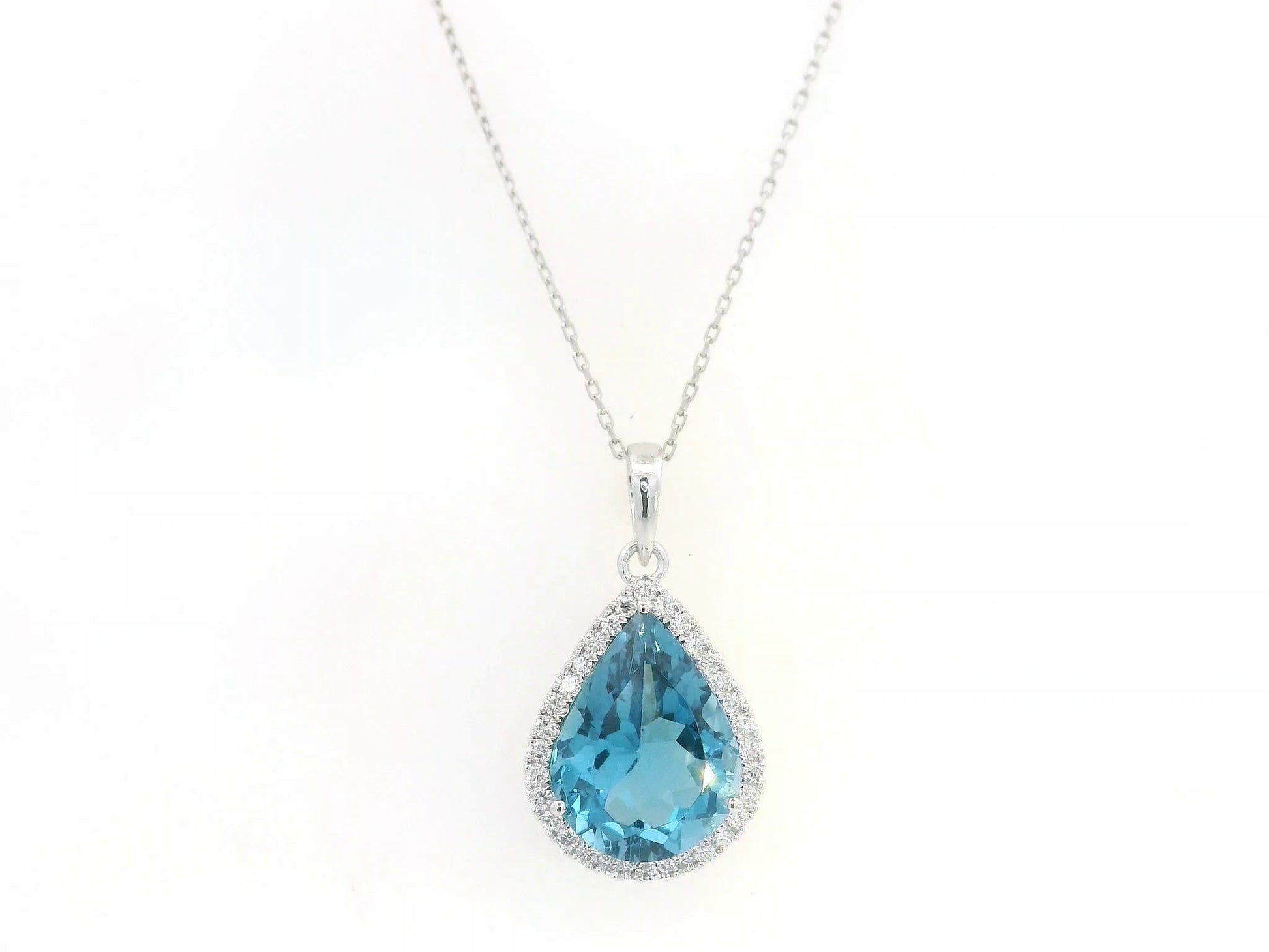 18K white gold pear shape London Blue Topaz pendant with diamond halo featuring a 9.10 carat natural London Blue Topaz and 0.39 carat natural diamonds.