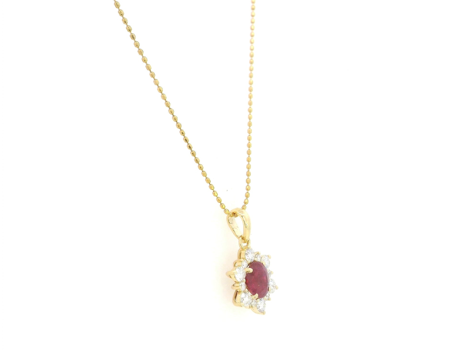 18K yellow gold oval ruby halo pendant featuring a 1.09 carat natural ruby surrounded by 0.48 carat natural diamonds in a floral-inspired halo design, supplied without a chain.