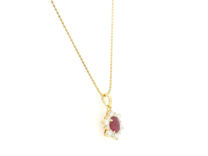 18K yellow gold oval ruby halo pendant featuring a 1.09 carat natural ruby surrounded by 0.48 carat natural diamonds in a floral-inspired halo design, supplied without a chain.