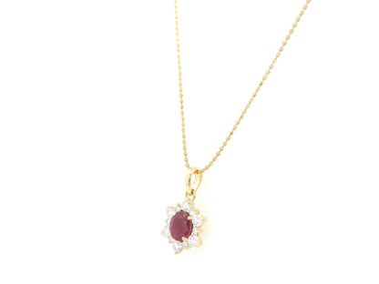 18K yellow gold oval ruby halo pendant featuring a 1.09 carat natural ruby surrounded by 0.48 carat natural diamonds in a floral-inspired halo design, supplied without a chain.