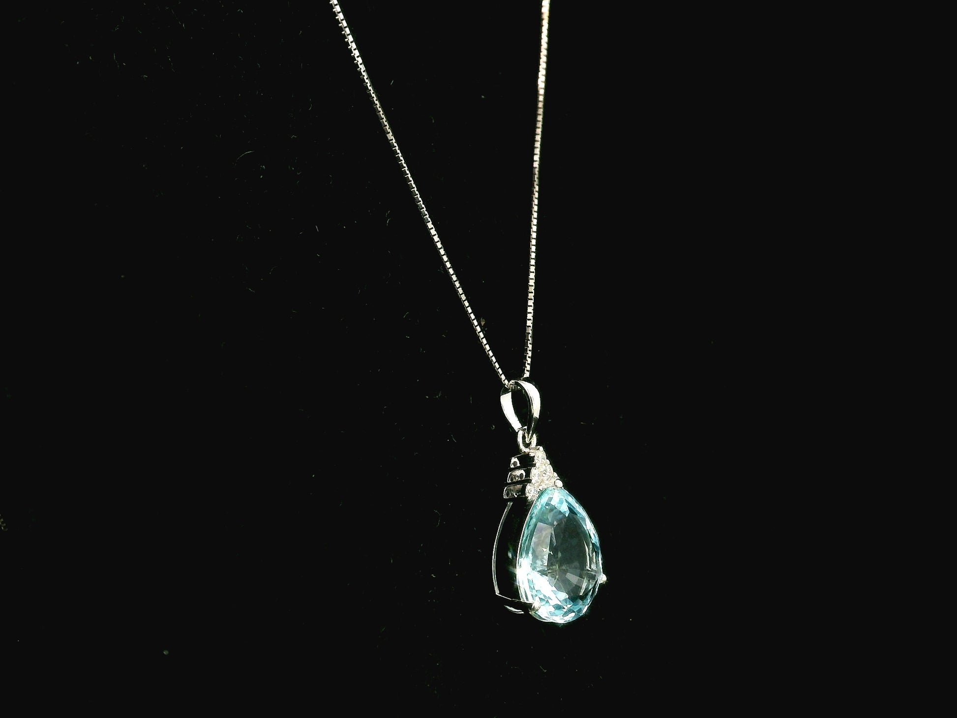 18K white gold pendant featuring a 10.82 carat natural pear-shaped aquamarine accented with 0.13 carat natural round brilliant diamonds. 