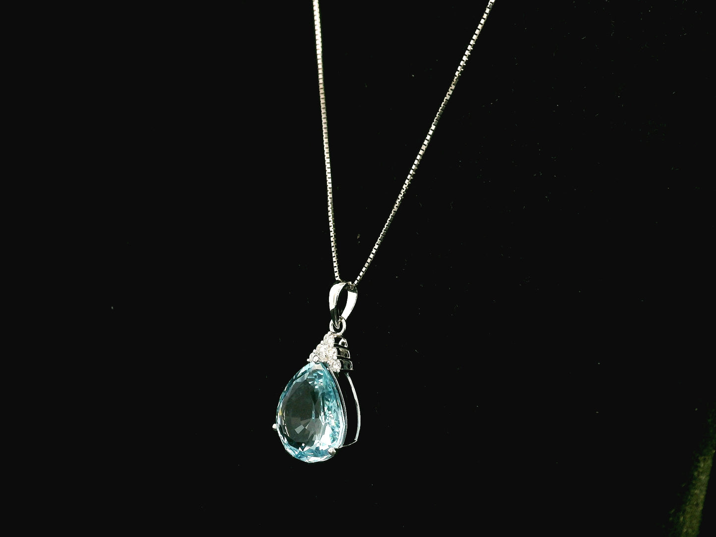 18K white gold pendant featuring a 10.82 carat natural pear-shaped aquamarine accented with 0.13 carat natural round brilliant diamonds. 