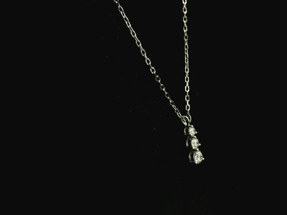 18K white gold three stone natural diamond journey pendant necklace featuring 0.36 carat round brilliant diamonds in a vertical prong setting with matching white gold chain.