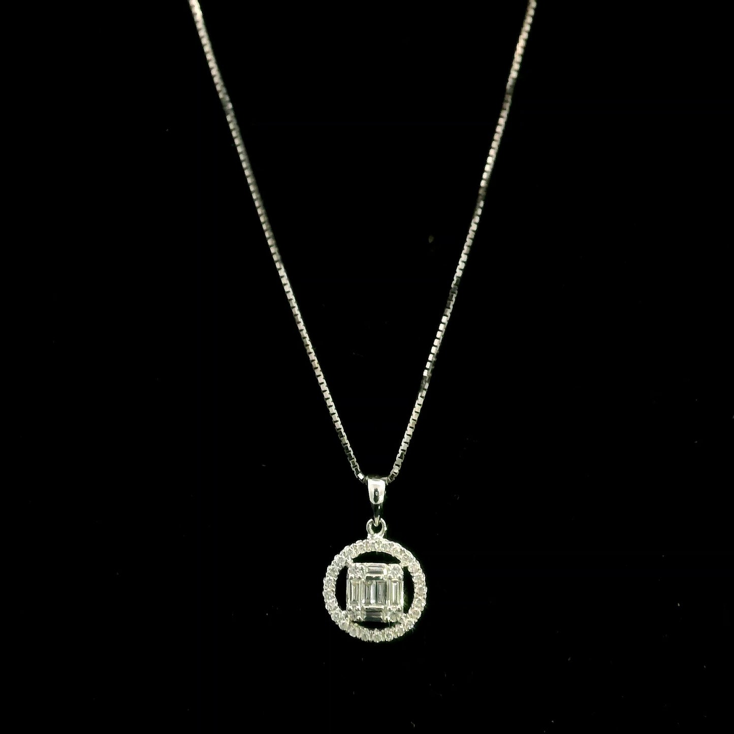 18K white gold diamond pendant featuring round and baguette natural diamonds in an emerald-cut inspired illusion cluster with a sparkling round diamond halo. Chain not included.