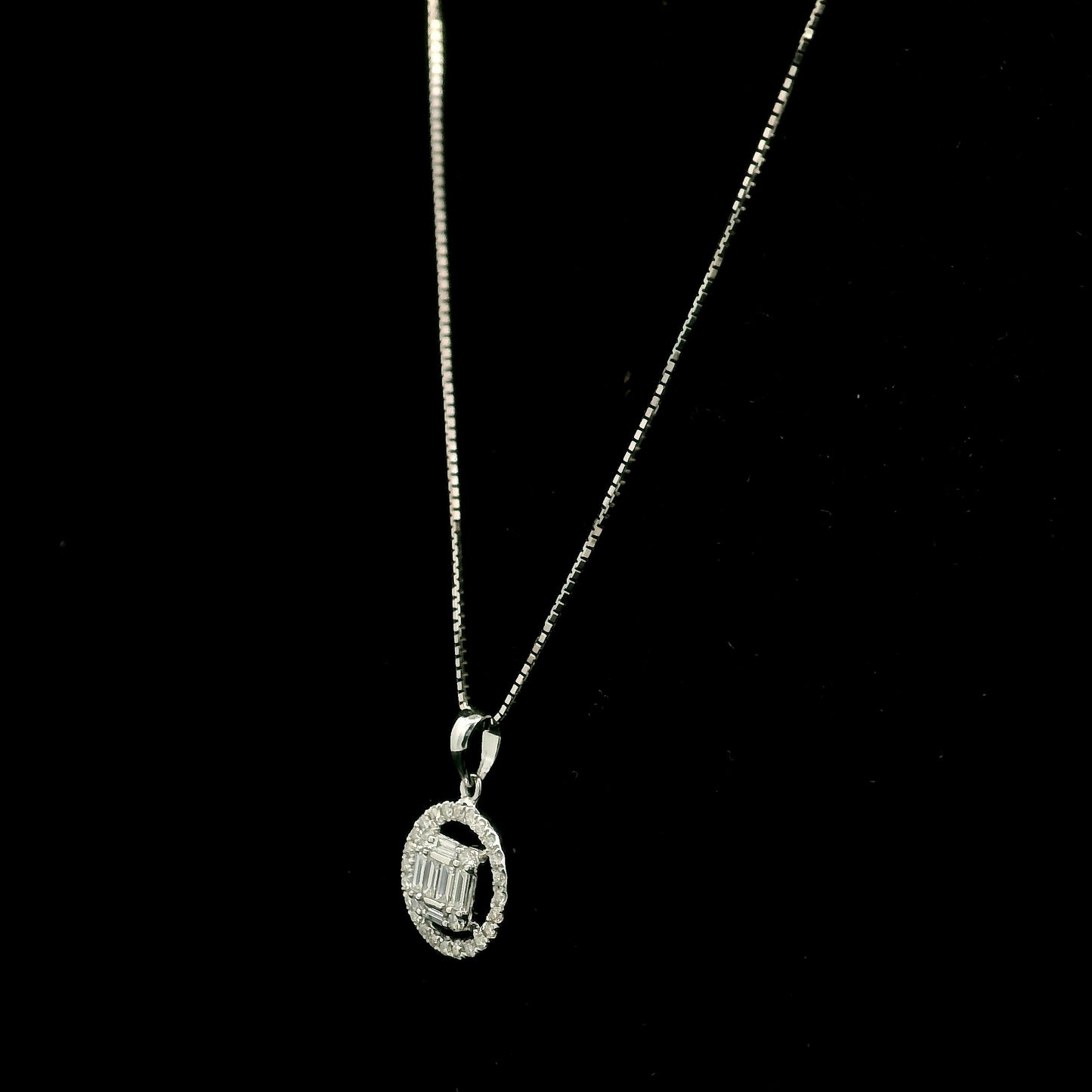18K white gold diamond pendant featuring round and baguette natural diamonds in an emerald-cut inspired illusion cluster with a sparkling round diamond halo. Chain not included.