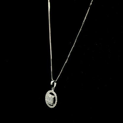 18K white gold diamond pendant featuring round and baguette natural diamonds in an emerald-cut inspired illusion cluster with a sparkling round diamond halo. Chain not included.