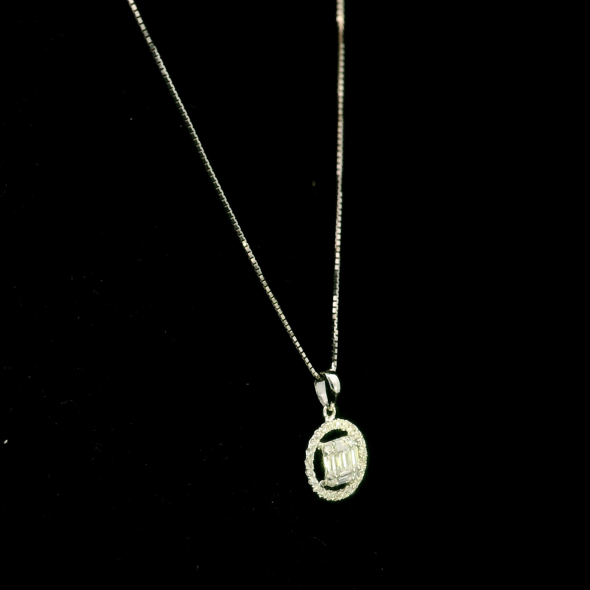 18K white gold diamond pendant featuring round and baguette natural diamonds in an emerald-cut inspired illusion cluster with a sparkling round diamond halo. Chain not included.