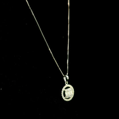 18K white gold diamond pendant featuring round and baguette natural diamonds in an emerald-cut inspired illusion cluster with a sparkling round diamond halo. Chain not included.